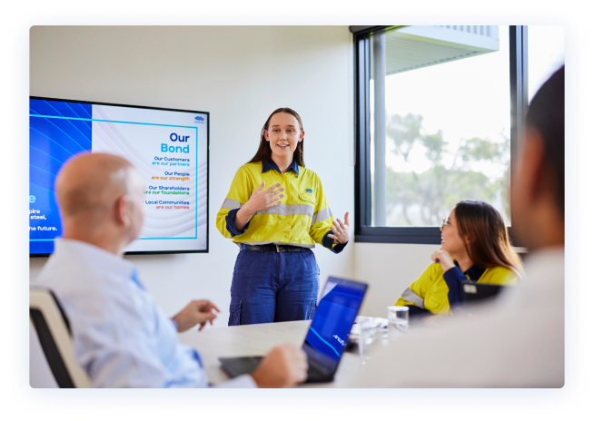 Young BlueScope employee presenting during a board meeting