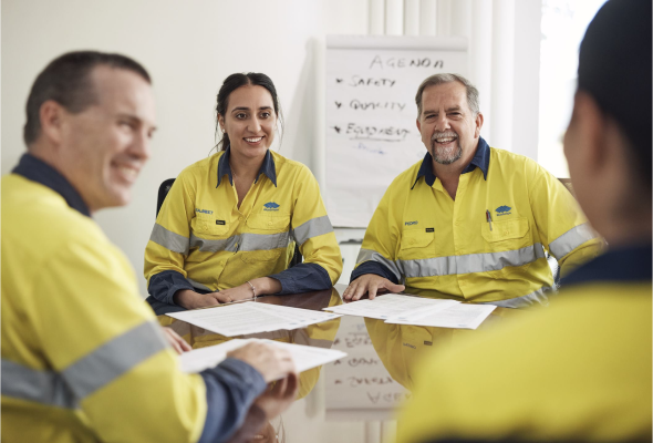 BlueScope meeting featuring four employees in high-visibility jackets