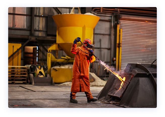 Employee in protective clothing working in a steelworks