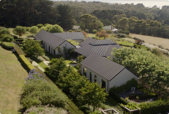 Three one-story buildings tucked away in a green valley