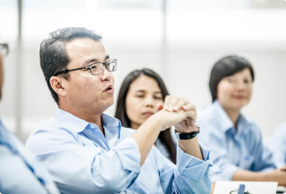 BlueScope employees in discussion during a meeting